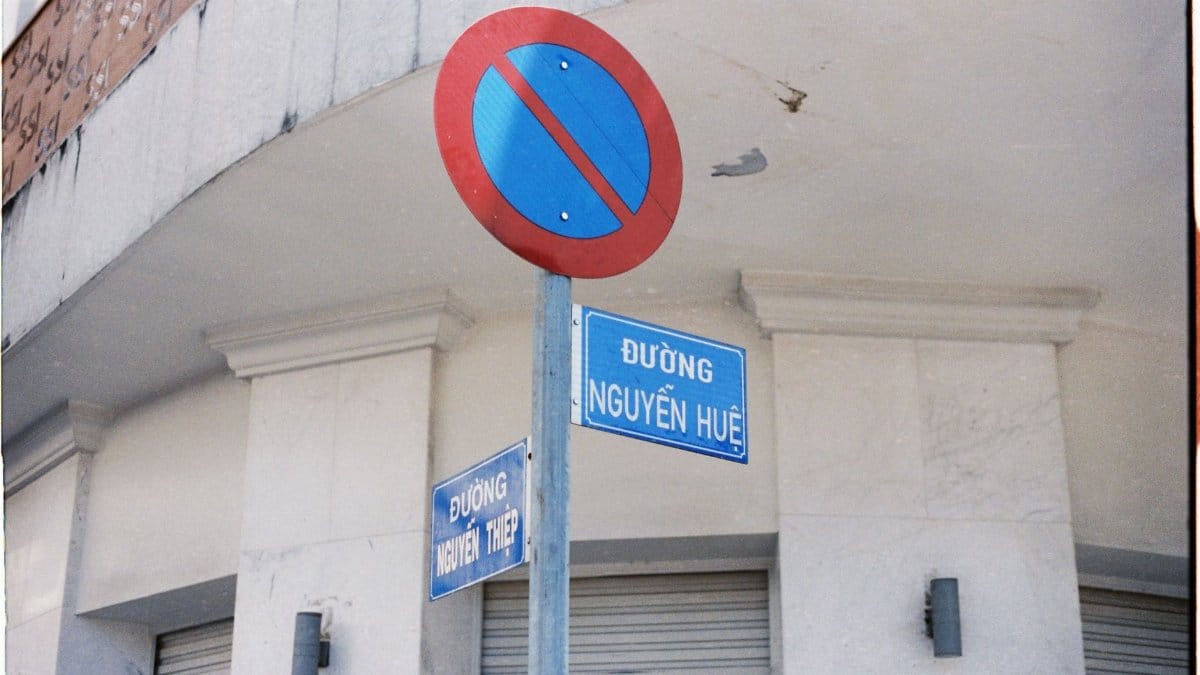 No parking sign and street signs on Nguyễn Huệ, urban Vietnamese street scene.