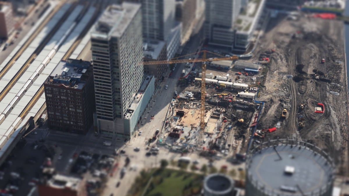 An aerial tilt-shift view of a bustling construction site in downtown Chicago, showcasing urban development.