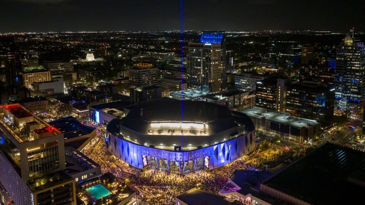 Aerial view of Golden 1 Center illuminated at night in downtown Sacramento, California.