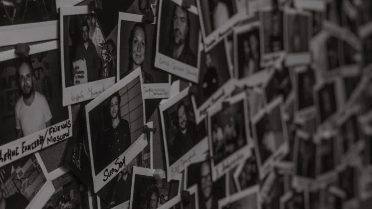 A wall filled with black-and-white Polaroid photos captured in a vintage style in Kyiv, Ukraine.