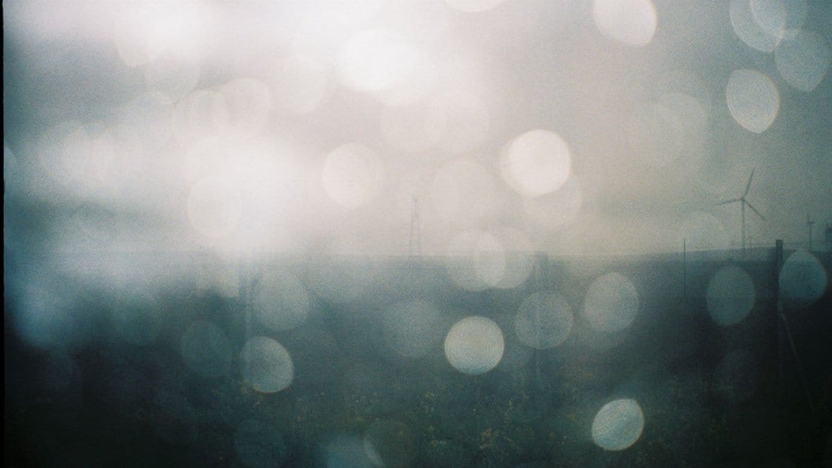 Misty landscape with wind turbines and bokeh effect in Inner Mongolia, China.