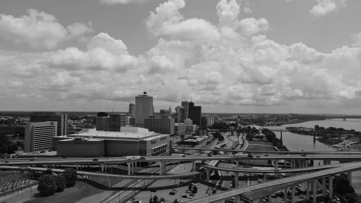 Aerial view of Memphis skyline with highways and river in black and white.