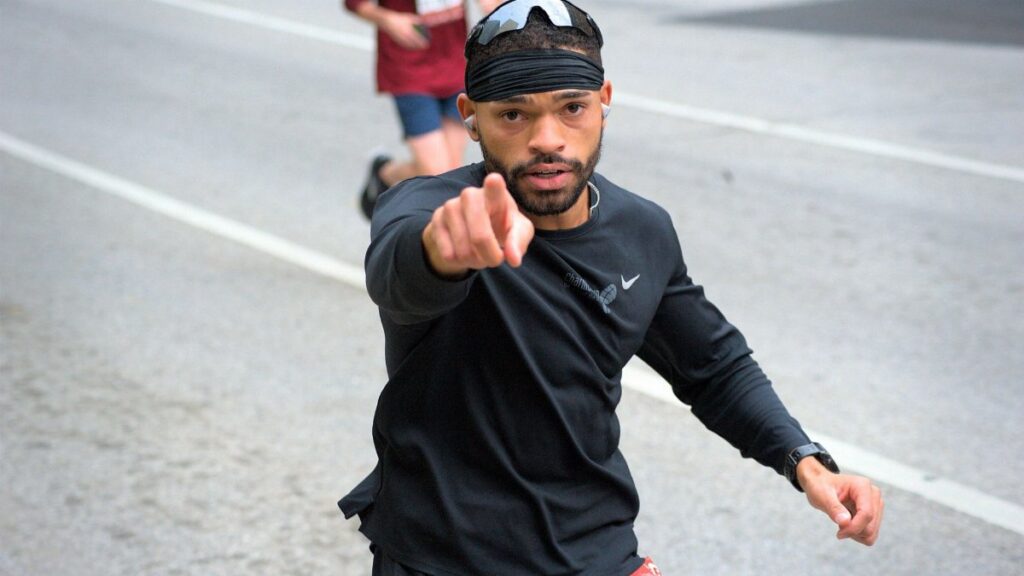 Focused marathon runner in downtown Baltimore participating in a race.