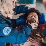 Paramedics administer life-saving CPR to unconscious patient during emergency response.