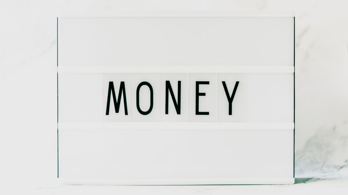 Contemporary minimalist lightbox displaying the word 'Money' on a clean white background.