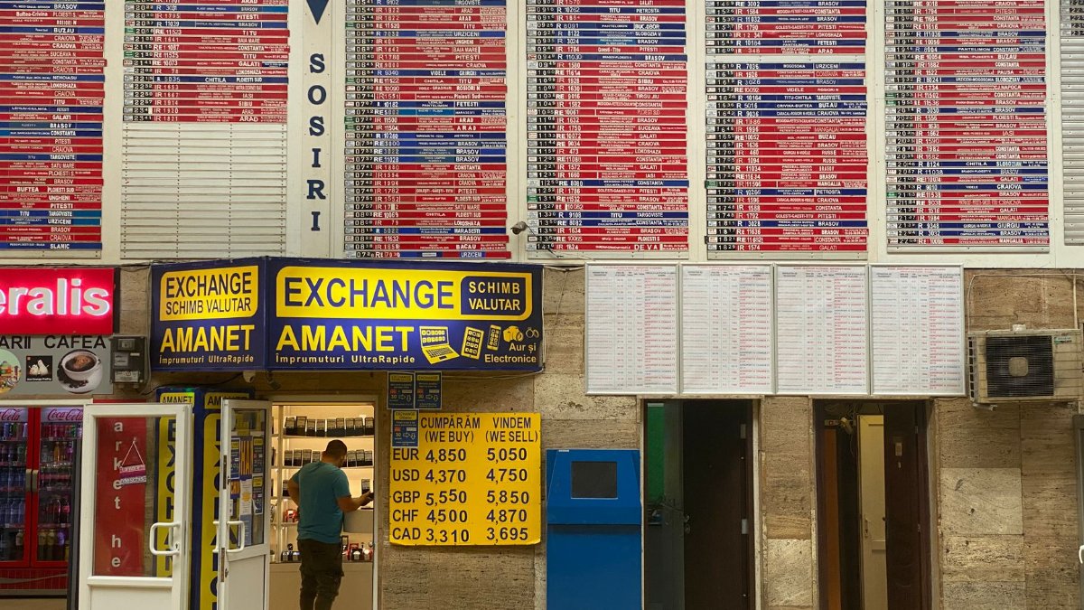 Currency exchange booth at Bucharest North Train Station with timetable overview.