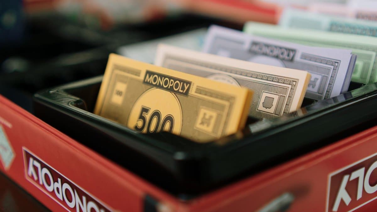 Detailed view of Monopoly game money and box, ideal for board game enthusiasts.