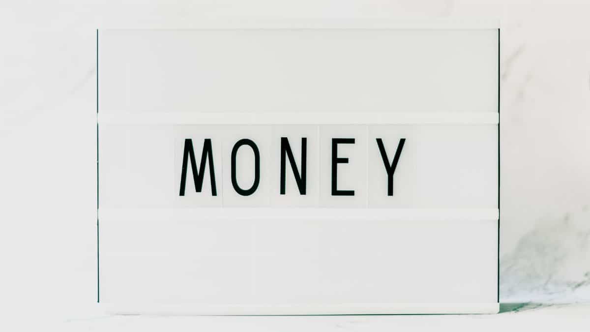 Contemporary minimalist lightbox displaying the word 'Money' on a clean white background.