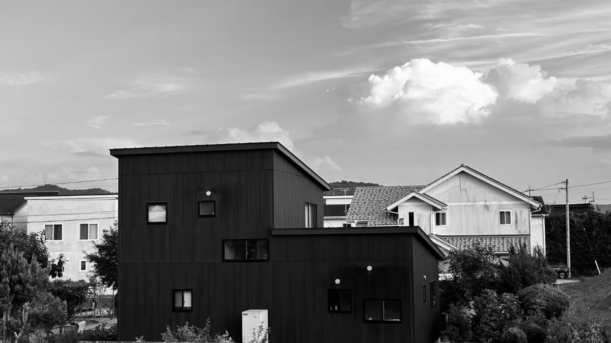 Elegant modern suburban house with minimalist design captured in black and white.