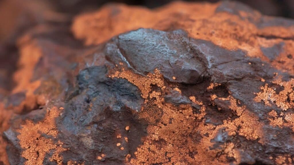 Detailed texture of iron ore rock in Minas Gerais, Brazil, showcasing earthy tones and mineral structures.