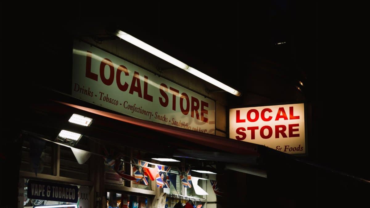 An urban local store glowing with neon signs during nighttime, capturing the essence of city nightlife.