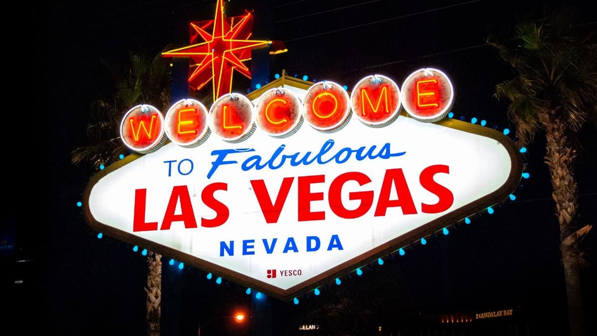 The iconic Welcome to Fabulous Las Vegas sign illuminated at night, representing the city's vibrant tourism.