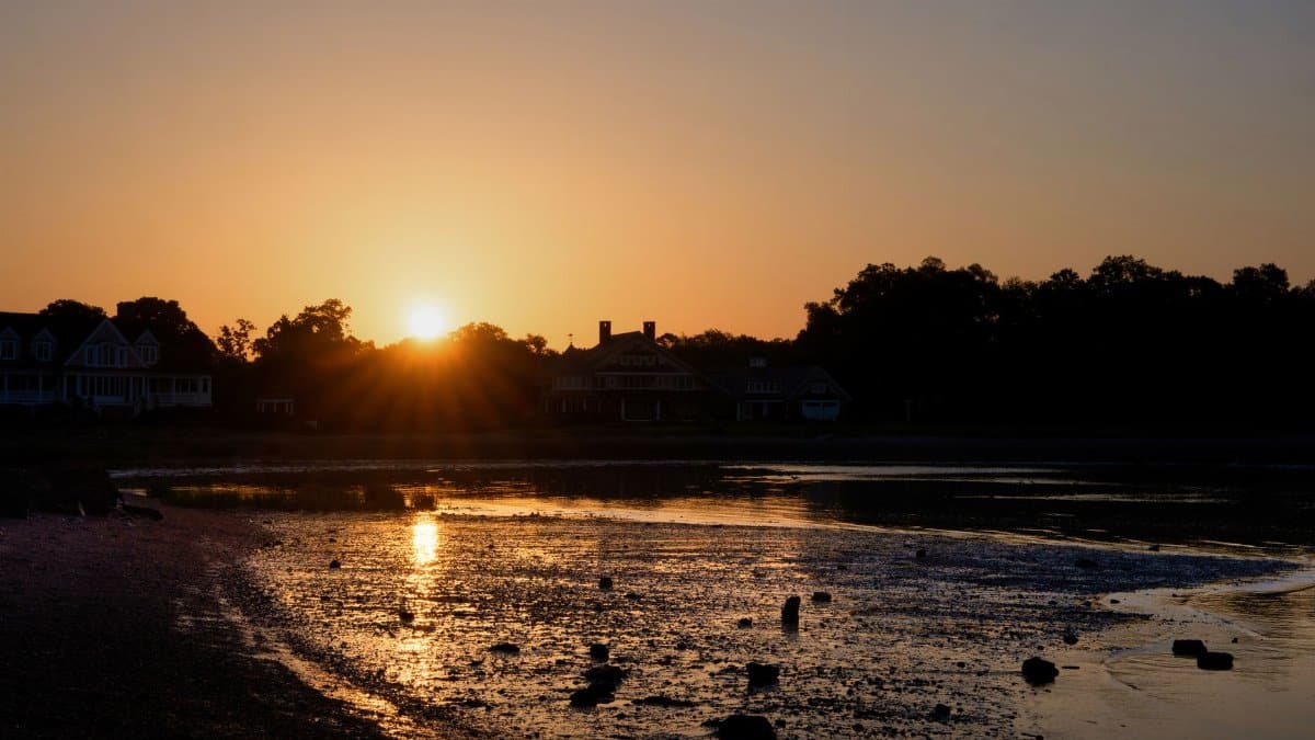 Beautiful sunrise over Cove Beach in Stamford, with low tide reflections and serene morning atmosphere.