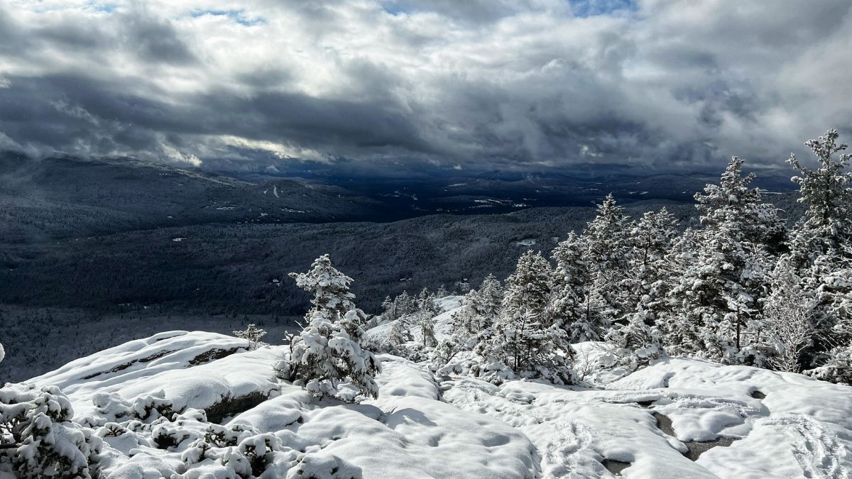 Breathtaking winter view of snow-covered trees and mountains in Lincoln, New Hampshire.