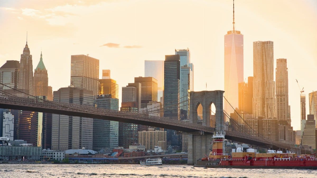 A stunning view of the Brooklyn Bridge and New York City's skyline at sunset.