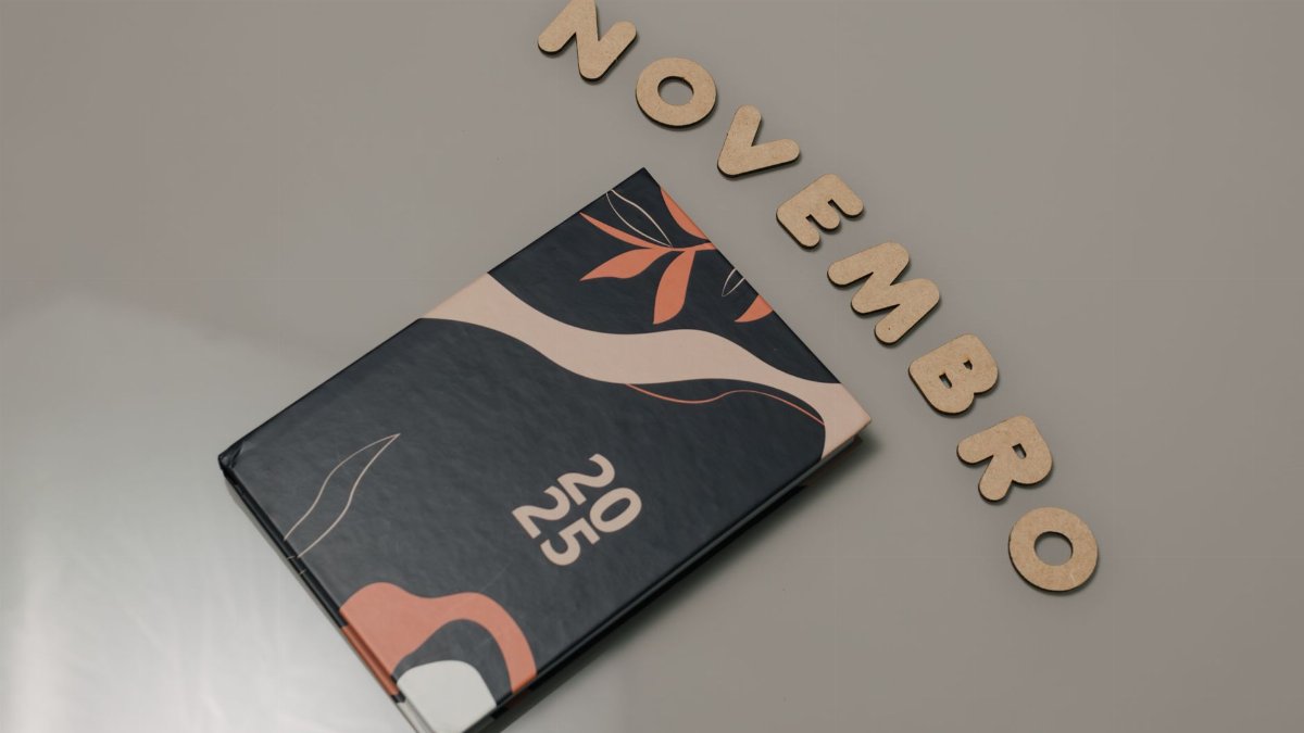 Stylish 2025 planner with abstract design and 'November' spelled out in wooden letters.
