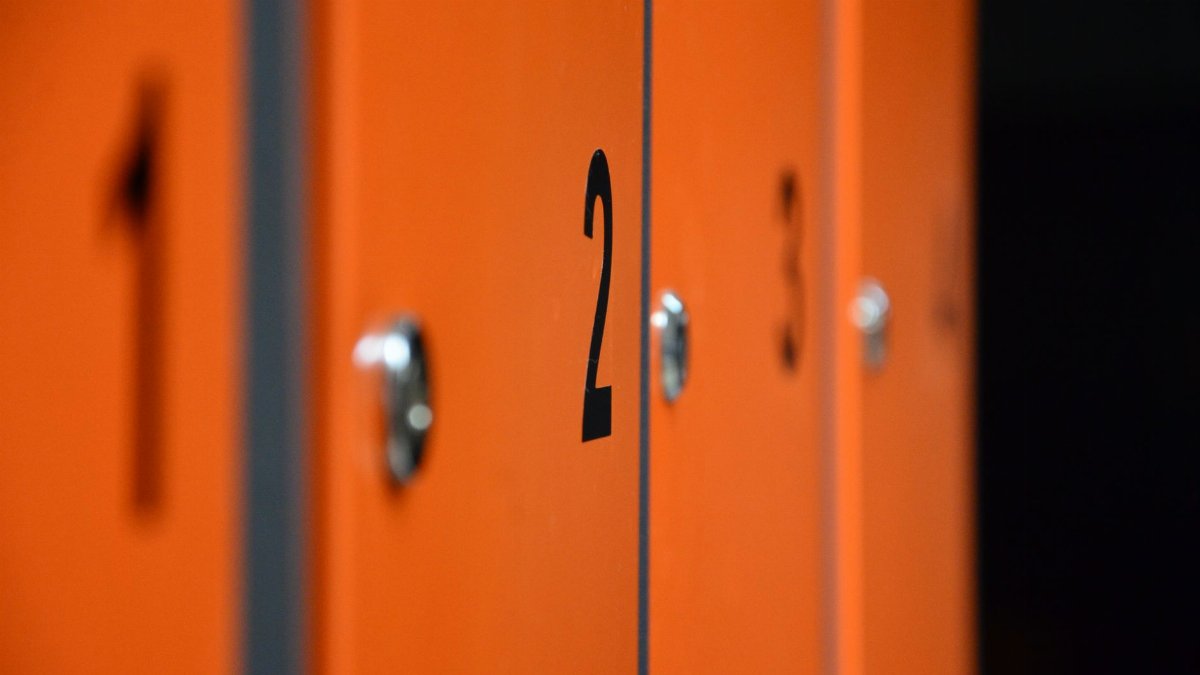 Close-up of orange lockers with numbers, focusing on locker number two.