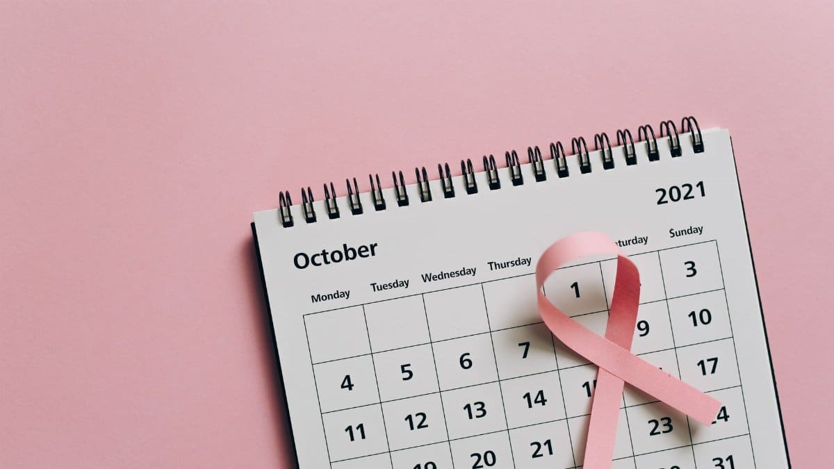 Pink ribbon on October calendar symbolizes breast cancer awareness.
