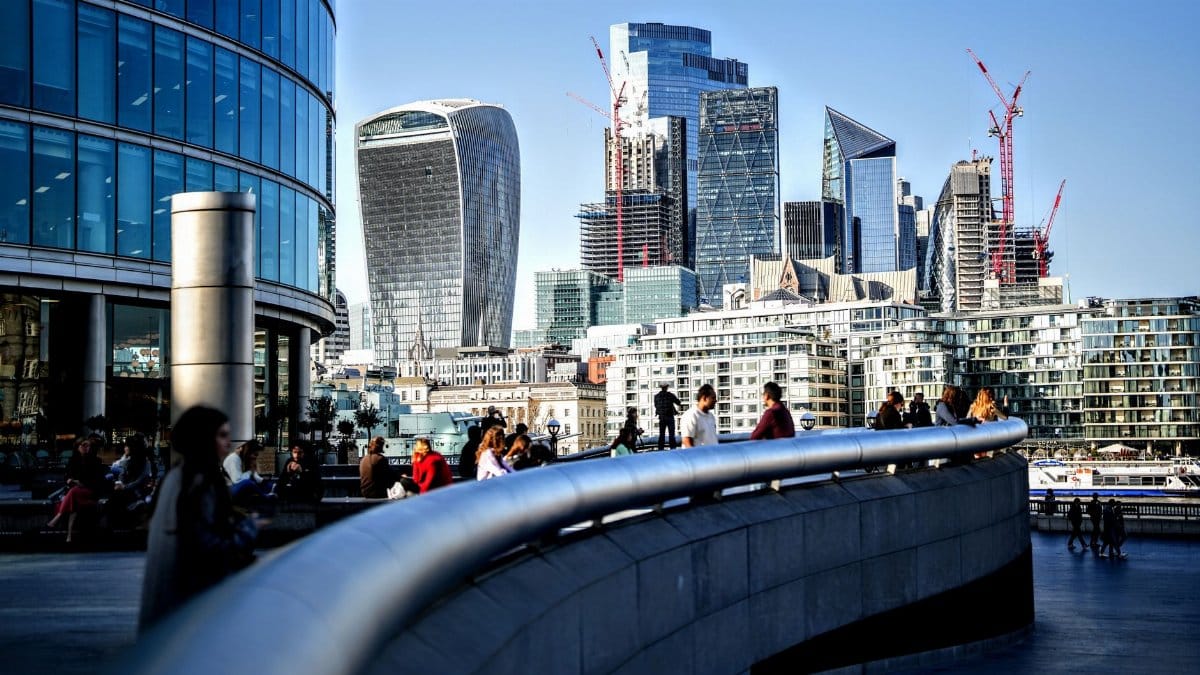 Dynamic view of London's skyline featuring modern skyscrapers and people enjoying the urban scenery.