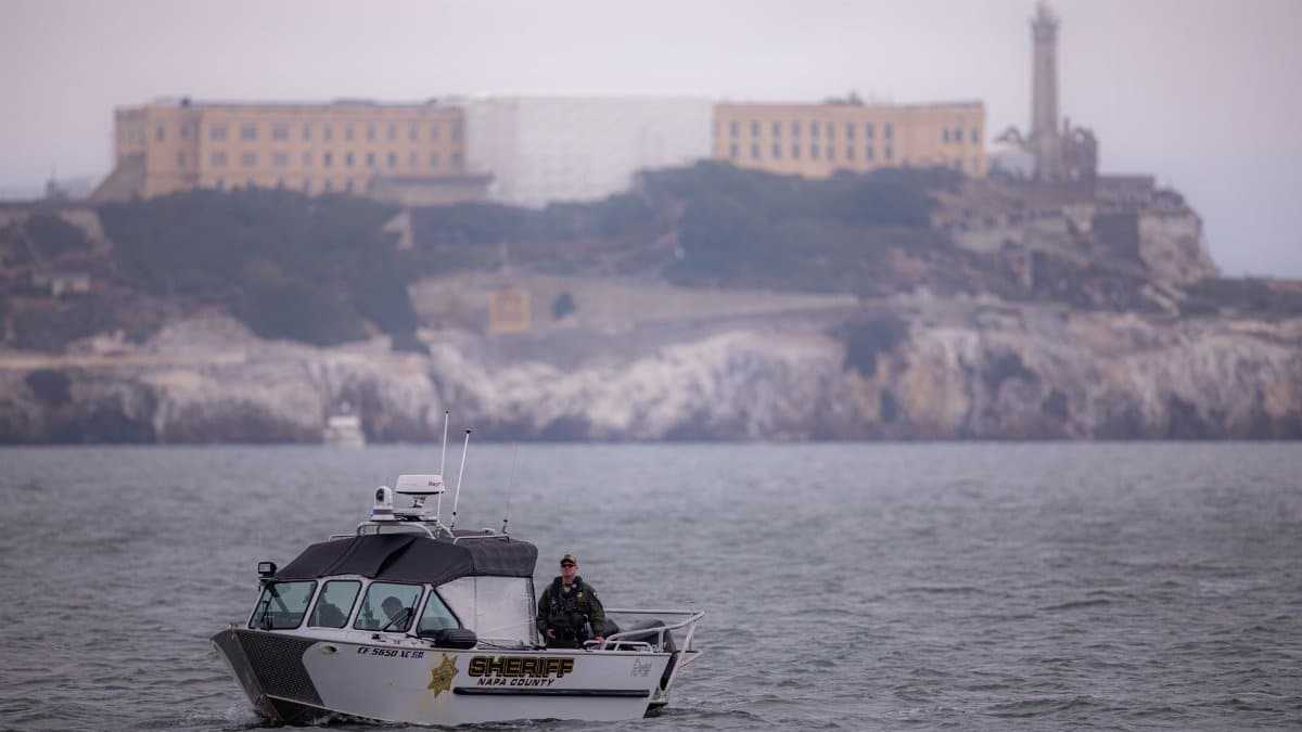 Sheriff boat patrols San Francisco Bay with Alcatraz Island in the background.