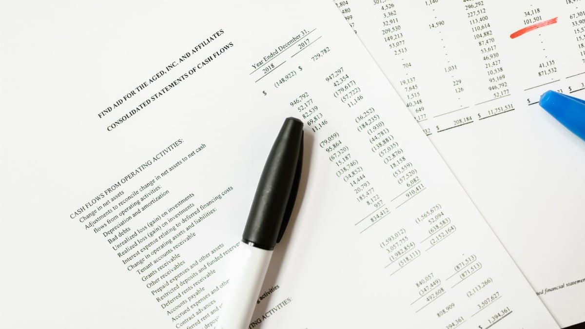 Financial documents featuring cash flows and pens, ideal for business themes and analysis.