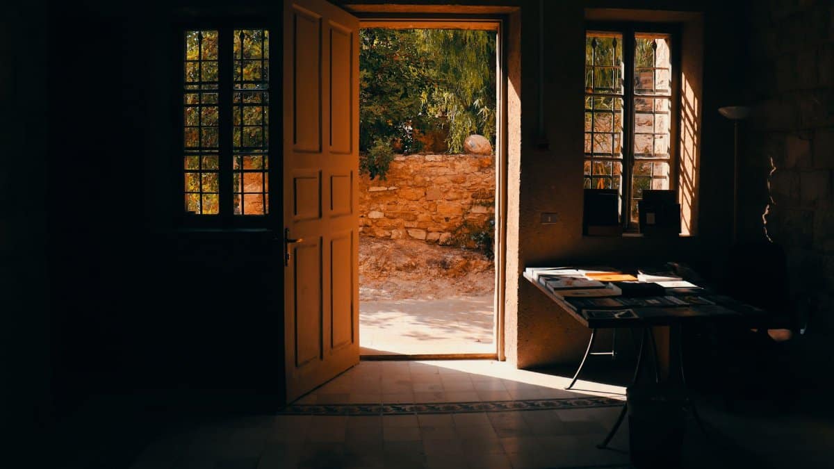 Warm sunlight streams through an open door in a traditional home interior in Amman, Jordan.