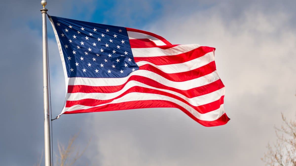 A bright, vivid display of the American flag waving against a blue sky in Canonsburg, Pennsylvania.