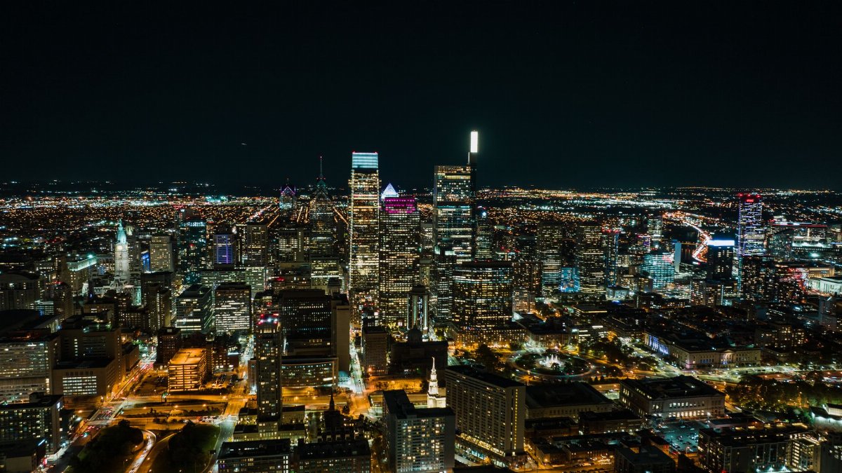 Stunning aerial view of Philadelphia at night showcasing skyscrapers and city lights.