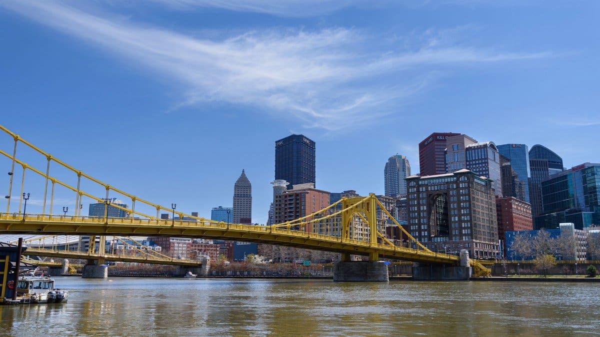 Scenic view of the Pittsburgh skyline featuring the yellow bridge on a clear day.