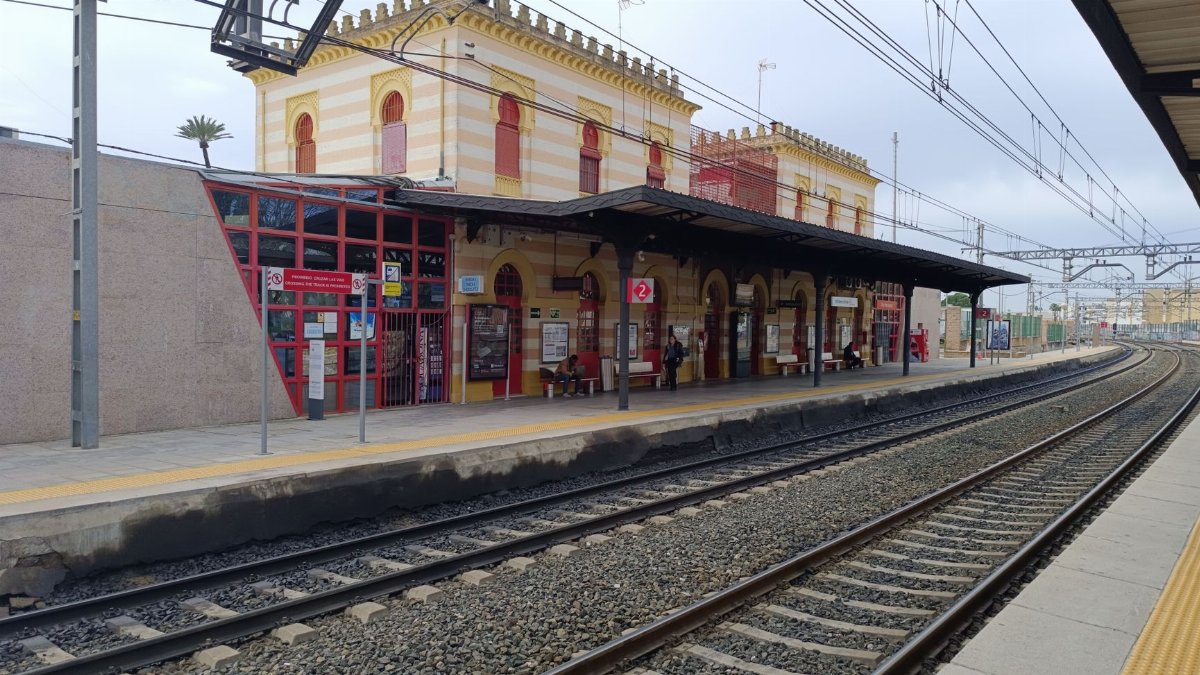 Charming Dos Hermanas train station in Andalucía, Spain, showcasing classic architecture and busy platforms.