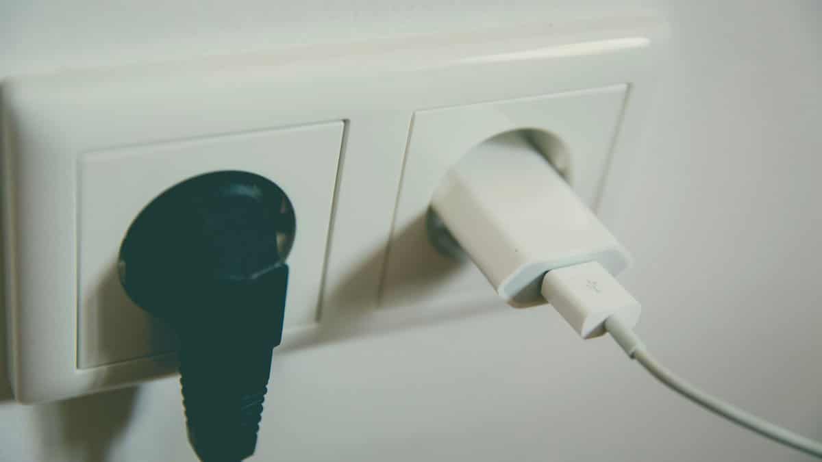 A close-up view of a wall outlet with two plugs inserted, capturing the simplicity of electrical connectivity.