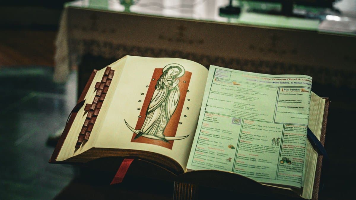 An open prayer book with religious imagery inside a church in Ireland, capturing spiritual essence.