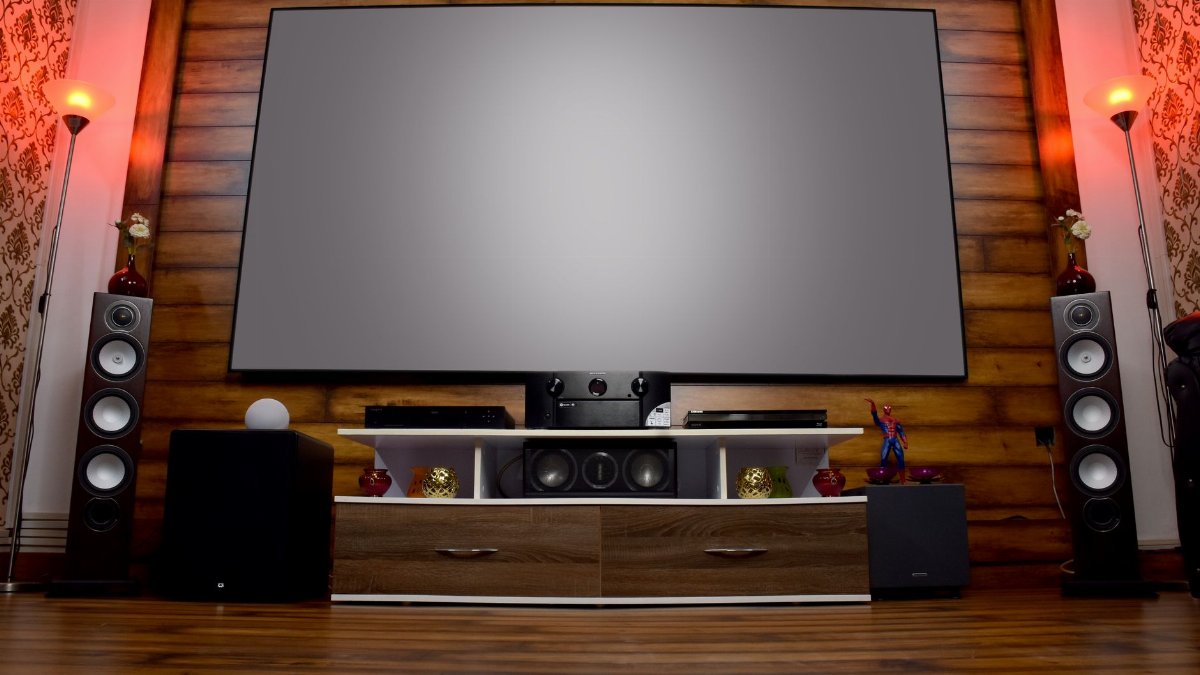 Stylish home theater featuring large screen, audio system, and decor, perfect for entertainment.