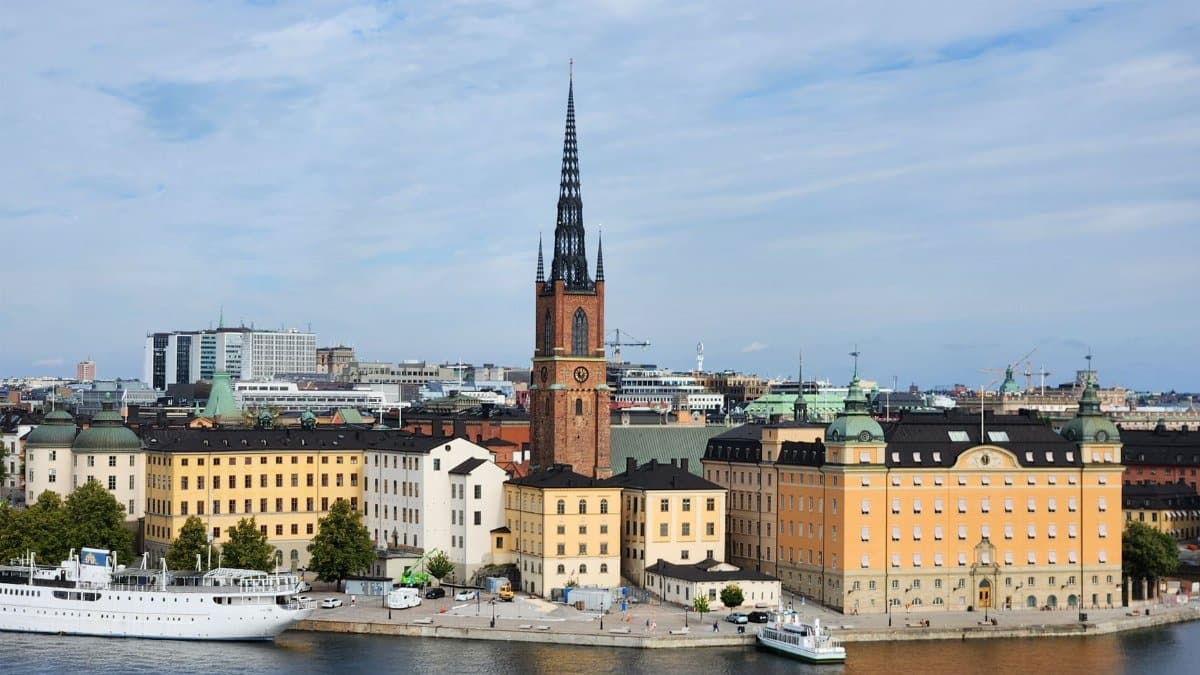 A stunning view of Riddarholmen Church and colorful buildings in Stockholm, Sweden.