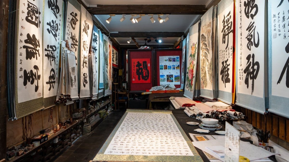 An indoor gallery showcasing traditional Asian calligraphy art and cultural scrolls.