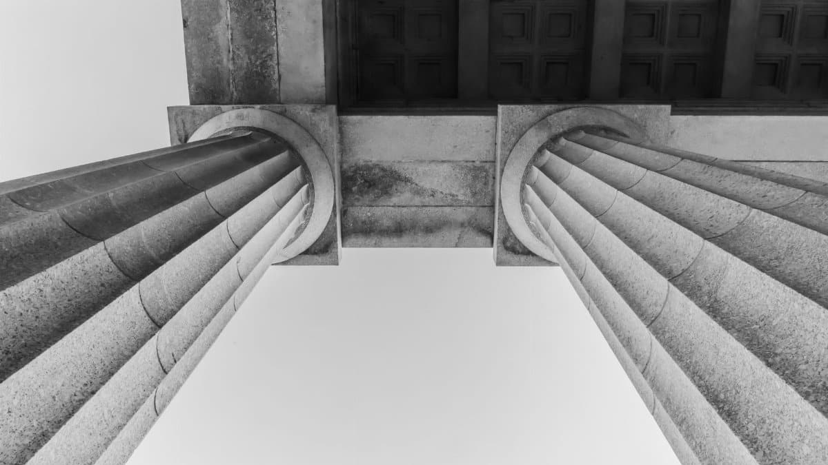 Black and white photo showcasing elegant architectural columns at Melbourne's Shrine of Remembrance.