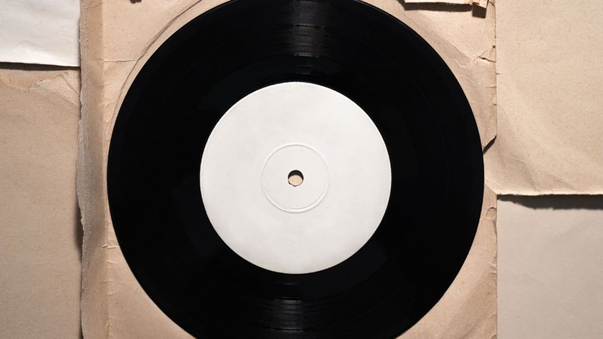 A classic vinyl record displayed on crumpled vintage paper, showcasing retro style.