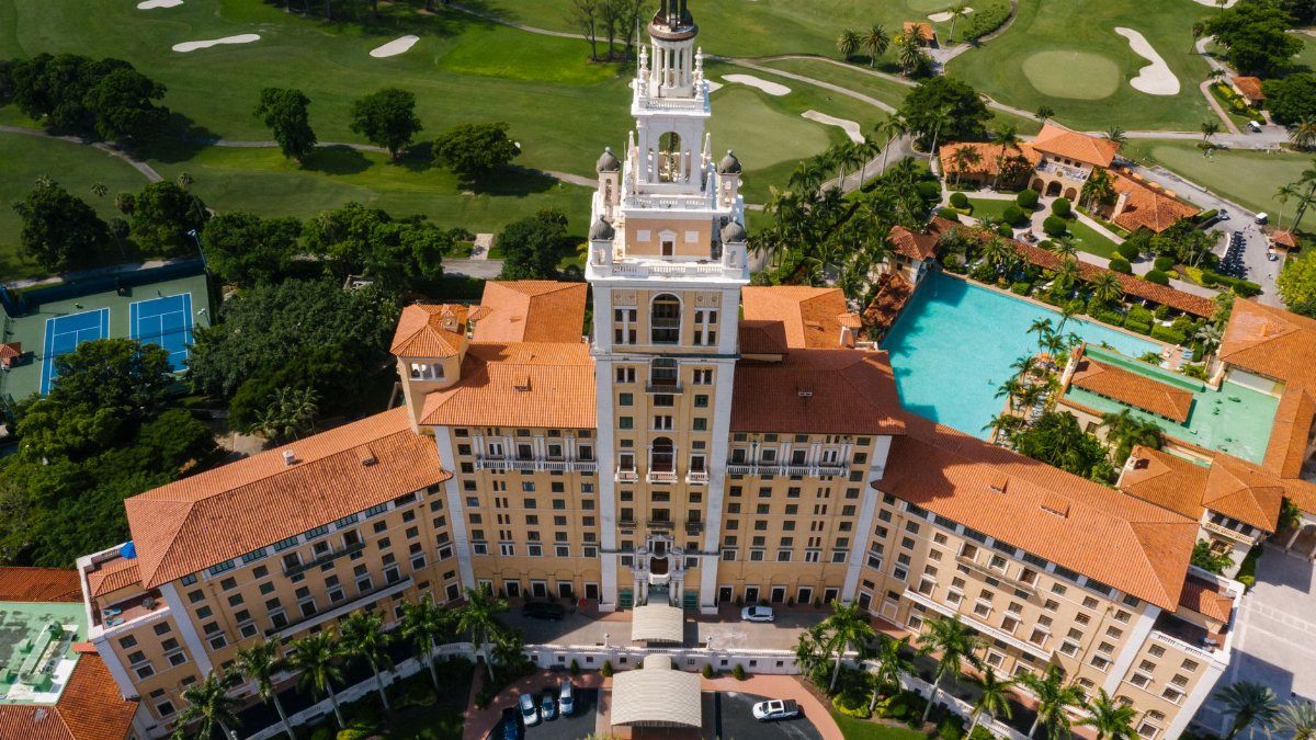 Stunning aerial shot of the historic Biltmore Hotel in Coral Gables, Florida, surrounded by lush greenery.