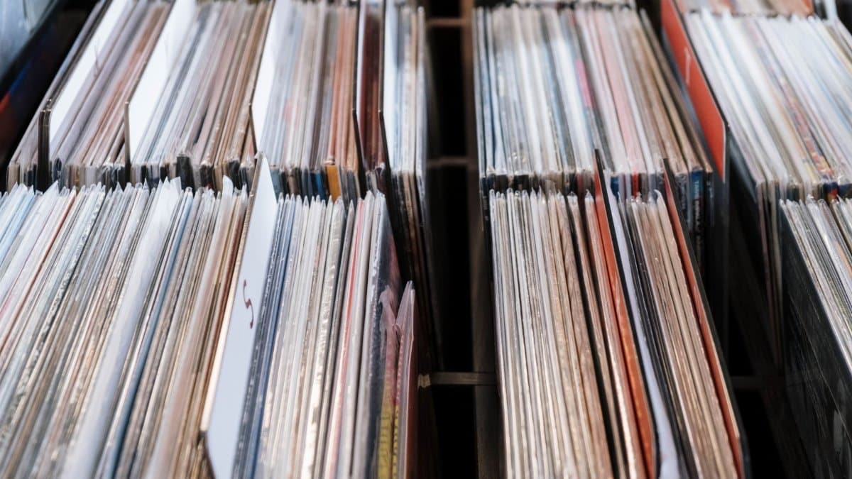 Close-up view of vintage vinyl records in a store setting, showcasing a retro music collection.