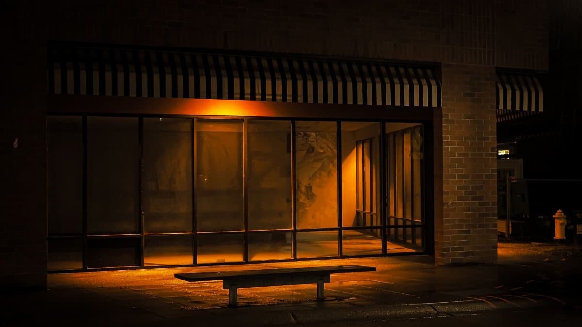 A dimly lit, empty bus stop in Redmond, WA at night, capturing urban solitude.