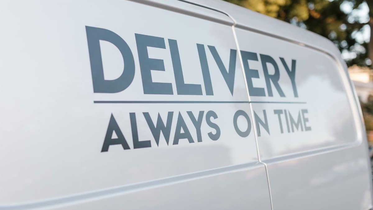 Close-up of delivery van with slogan 'Always On Time' emphasizing timely service.