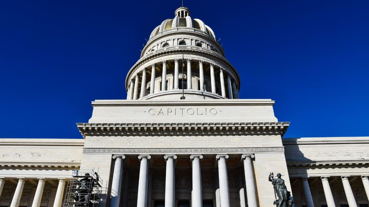 Low angle view of the iconic El Capitolio building under a clear blue sky in Havana, Cuba.