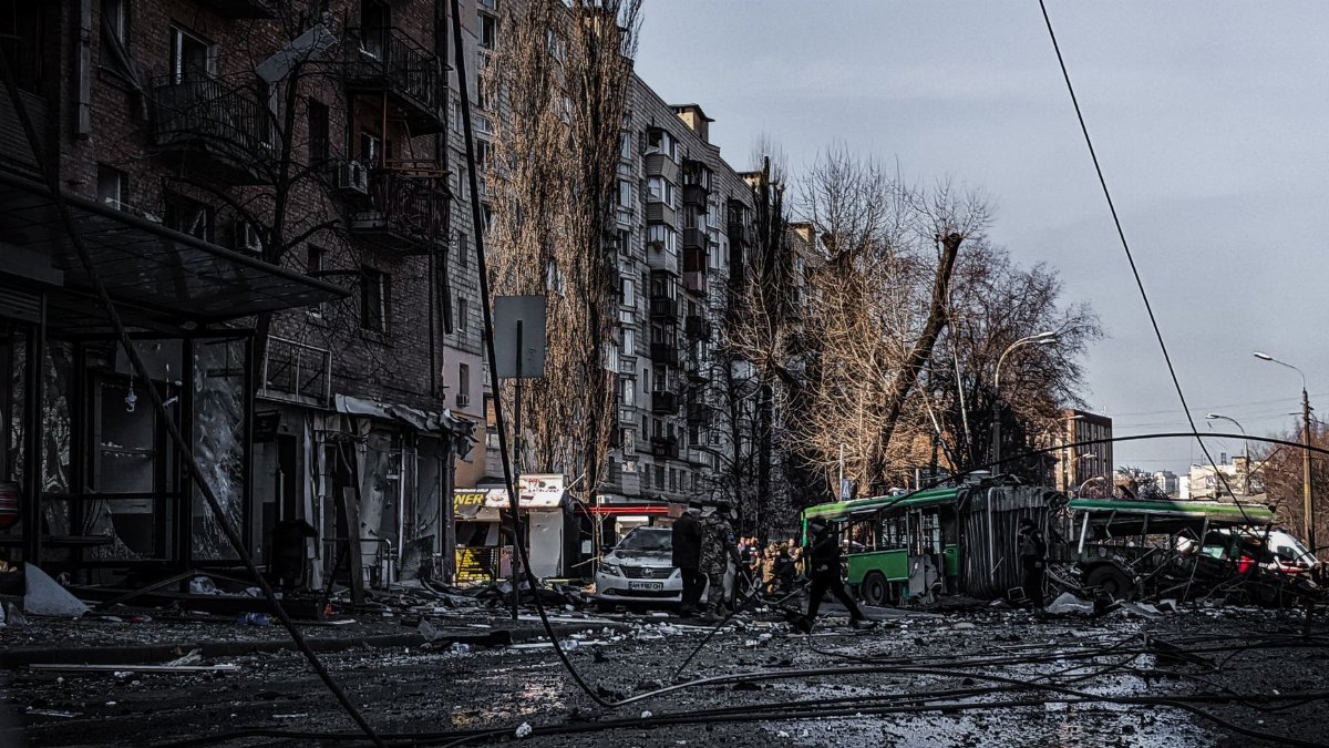 A war-damaged street in Kyiv, Ukraine, showing destruction and chaos.