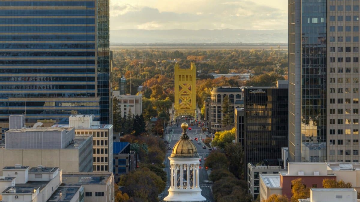Aerial view of Sacramento's skyline featuring the iconic Tower Bridge at sunset.