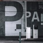 View of a modern urban parking garage in Seattle with graffiti and signage.