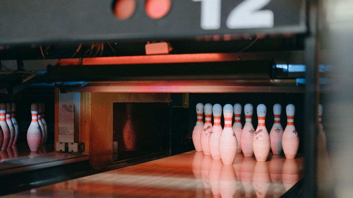 A vibrant shot of illuminated bowling pins ready for action in Lane 12 of a bowling alley.