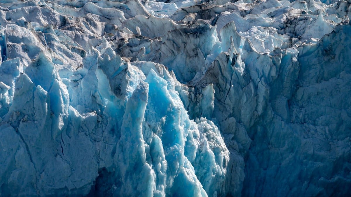 Close-up view of the vibrant blue Dawes Glacier in Alaska. A striking natural wonder illustrating climate change impacts.