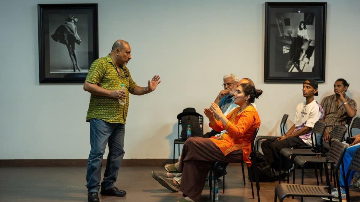 Speaker interacting with audience in a conference room setting.