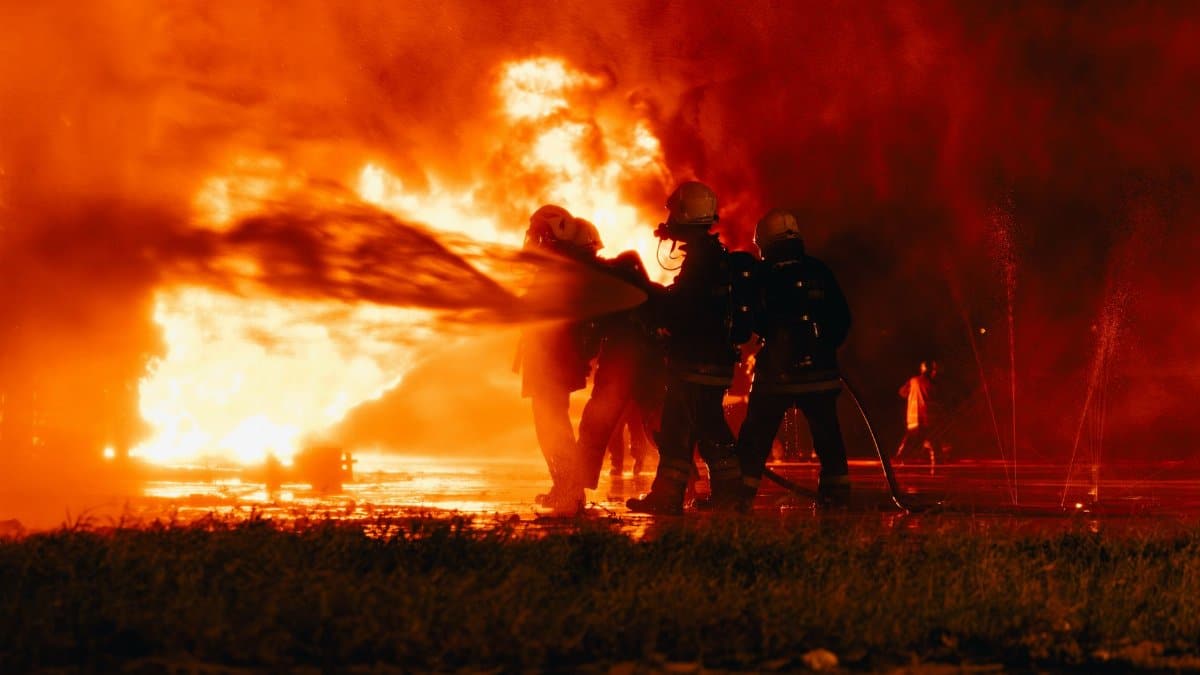 Firefighters bravely combat a raging fire at night in Libya, showcasing courage and teamwork.