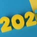 Yellow and blue foam numbers forming 2027 on vibrant blue and yellow background.